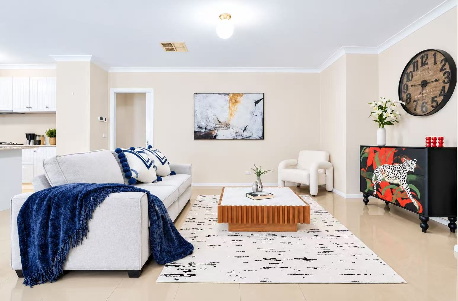 Bright family lounge at 9 Gilmore Grove Point Cook with white sofa, timber coffee table and open access to the kitchen